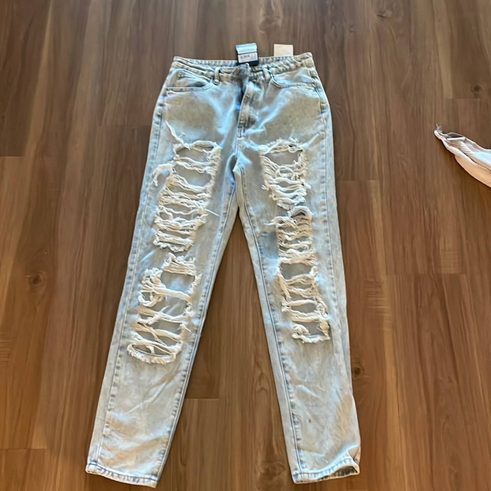 Light wash jeans- small stain next to rips